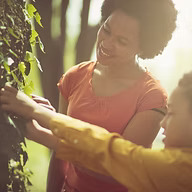 adult and child examining leaves